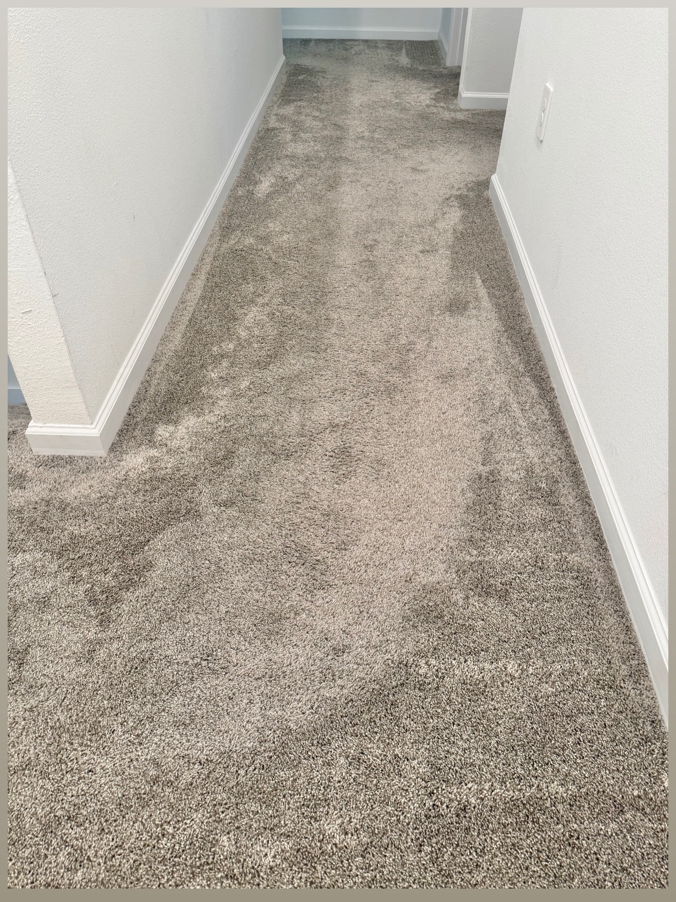 Carpeted hallway before flooring installation in Celebration, Florida