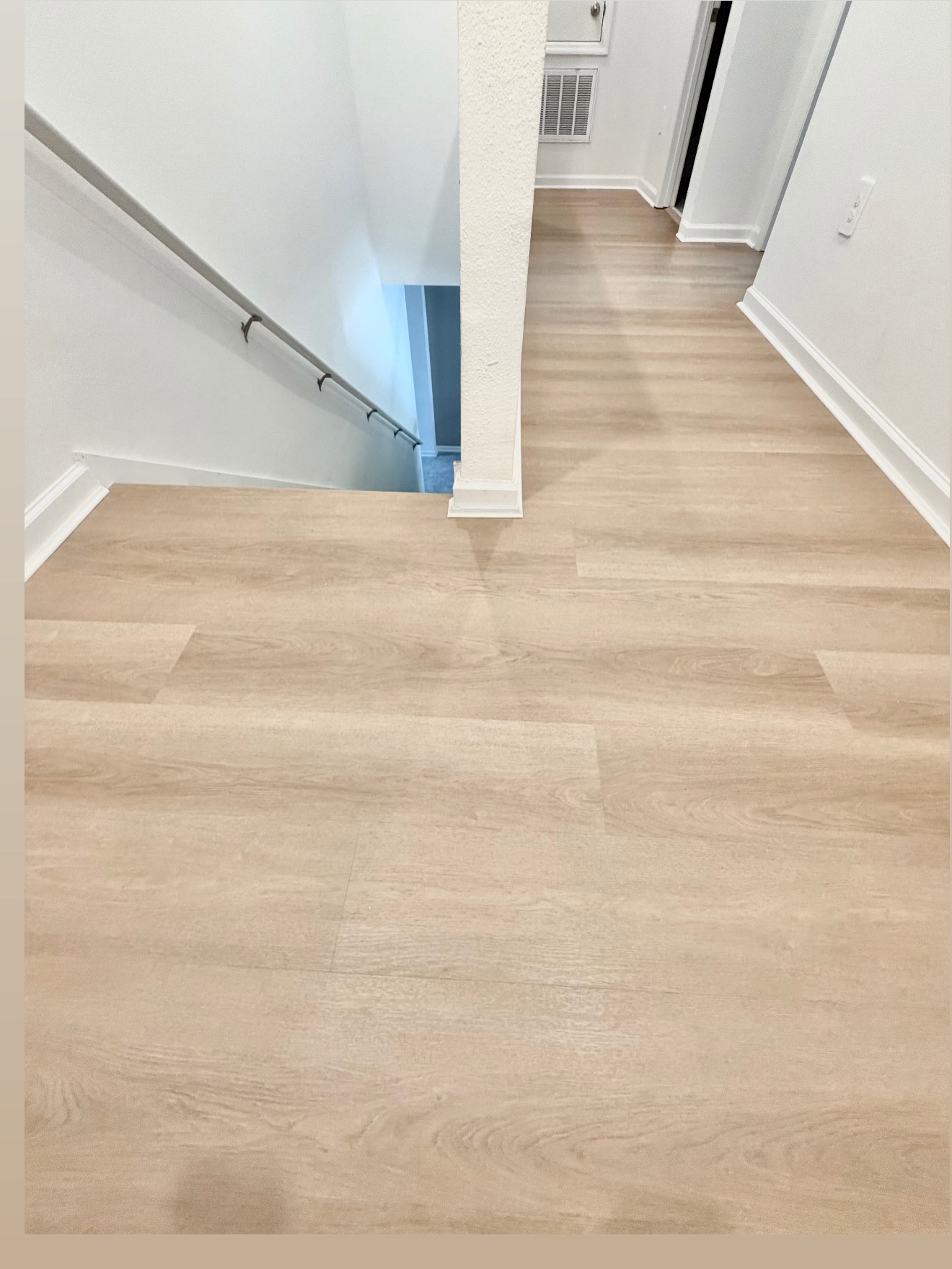 Pale wood-look LVP flooring on the landing and hallway in Celebration